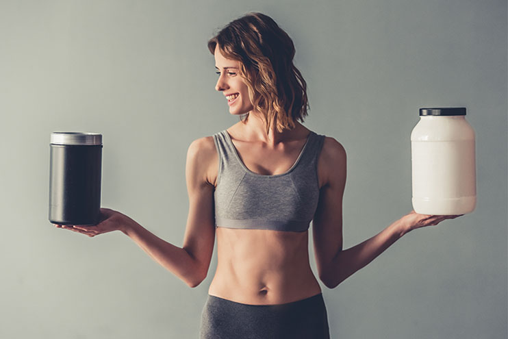Woman Choosing Between Protein Powders
